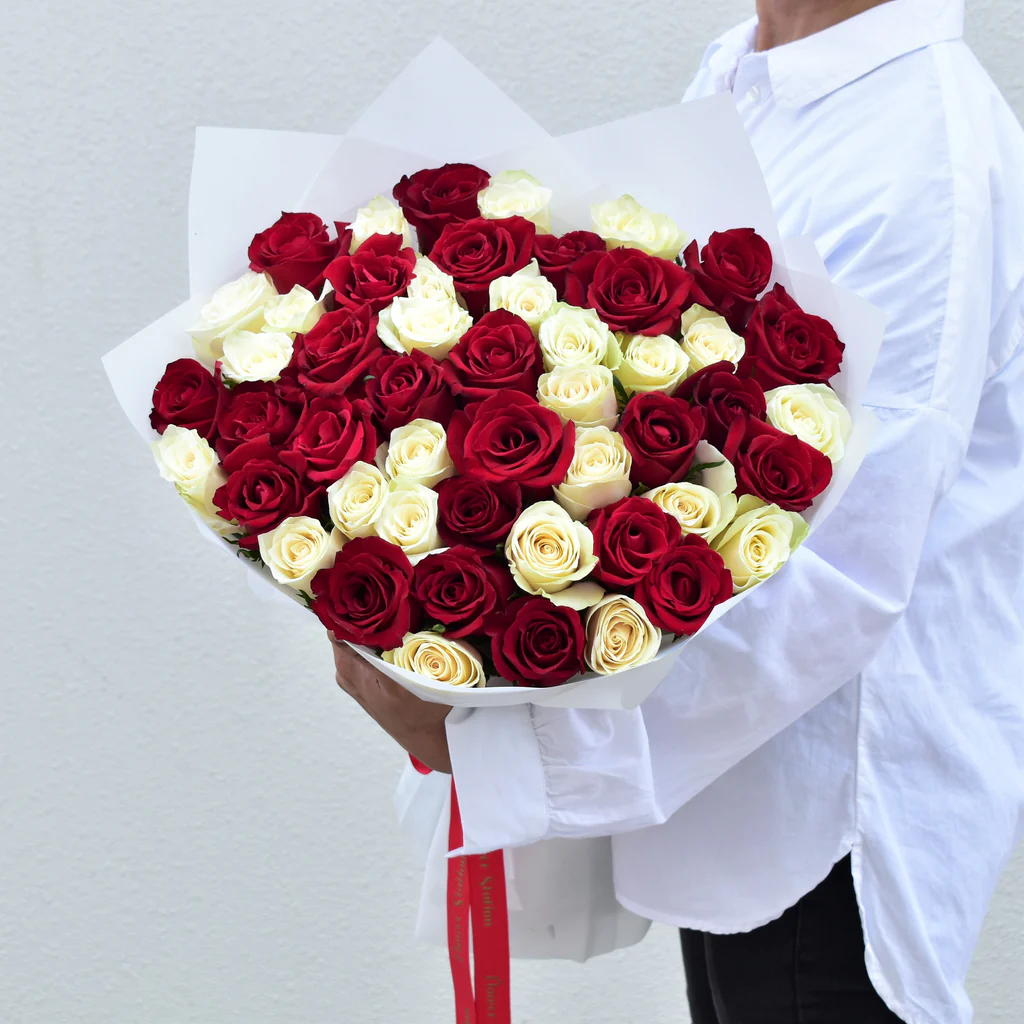A luxury hand-tied bouquet of premium red and white roses for a romantic Valentine's Day gift in the UAE.