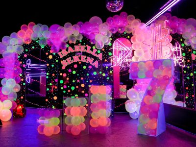 Elegant party backdrop decoration with organic balloons and neon signs in Dubai