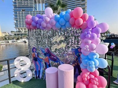 Trendy photo booth party setup with neon signs and aesthetic backdrops in Dubai
