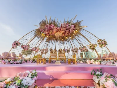 Luxurious entrance arch for wedding decoration Dubai featuring white florals and gold accents.