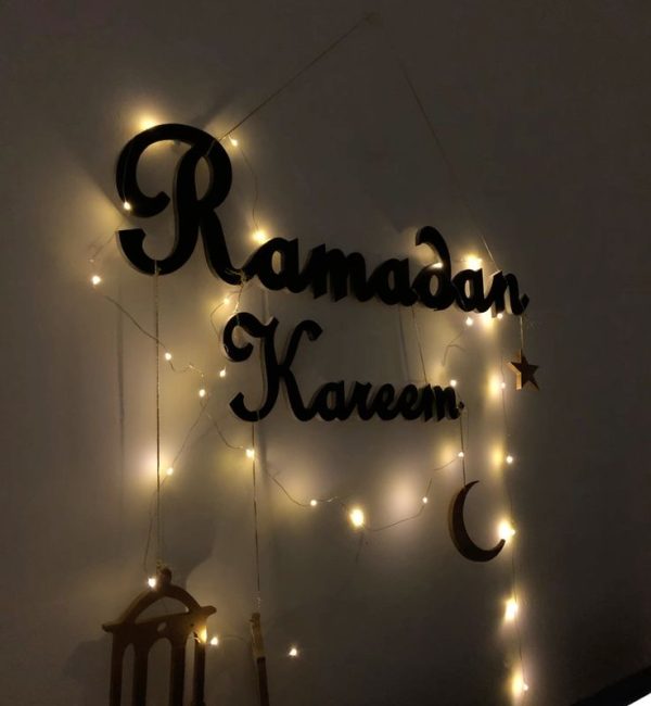 Elegant gold Ramadan Decoration wall hanging with crescent moon and star motifs in a modern Dubai villa.